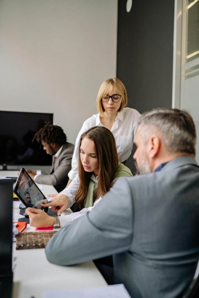 pexels-photo-7793096-7793096 Colleagues engaged in a business meeting, collaborating and discussing strategies in a modern office.
